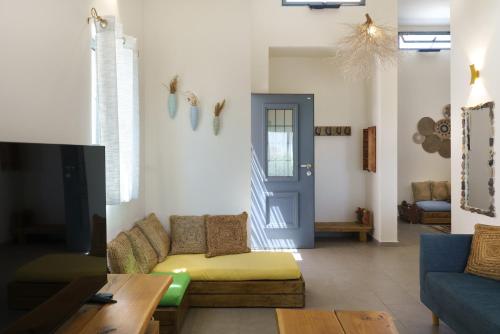 a living room with a couch and a tv at Nof Zuqim in Zuqim