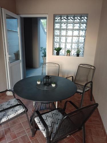 a black table and chairs in a living room at Natalija apartmani in Sveti Juraj