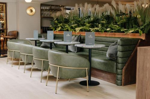 a restaurant with tables and chairs with laptops on them at Ty Glyn Hotel in Ciliau-Aeron