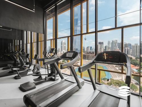 a gym with cardio machines and a view of the city at Opus by Soulasia in Kuala Lumpur