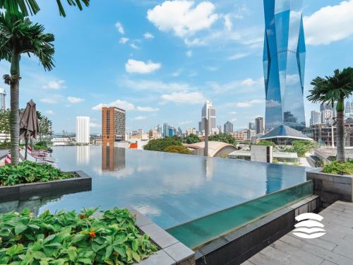 a swimming pool with a city skyline in the background at Opus by Soulasia in Kuala Lumpur