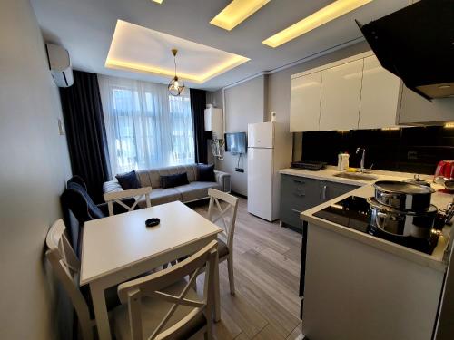 a kitchen and living room with a table and chairs at Levent Apart in Trabzon