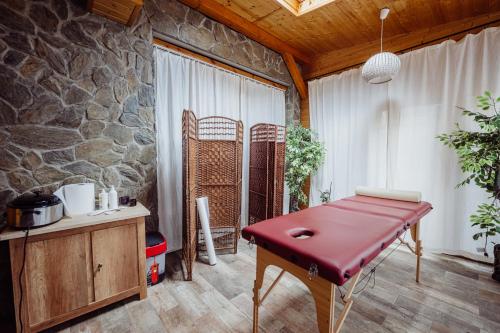 a red table in a room with a stone wall at Hotel Na Skarpie in Szklarska Poręba