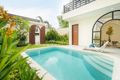 a swimming pool in the backyard of a house at Villa Amaia Canggu in Kerobokan
