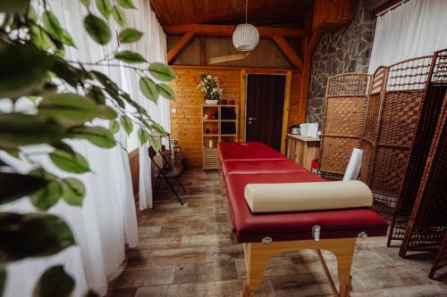 a room with a red bench and a table at Hotel Na Skarpie in Szklarska Poręba