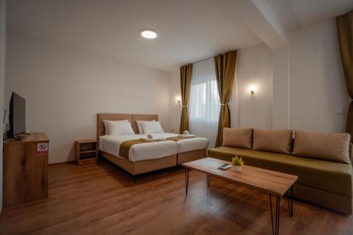 a living room with a bed and a couch at Villa Petra in Ohrid