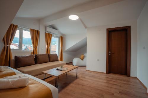 a living room with a couch and a table at Villa Petra in Ohrid