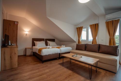 a living room with a bed and a couch at Villa Petra in Ohrid