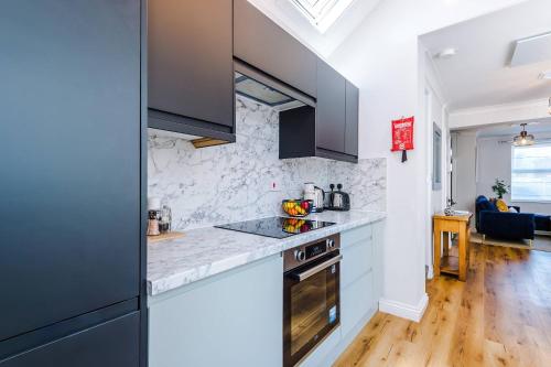 a kitchen with a counter top and a stove at Cozy 3-Bed Home by 53 Degrees Property, Perfect for Business & Groups! in Leek