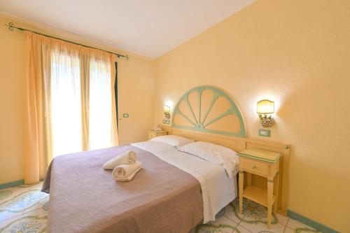a bedroom with a bed with a towel on it at La Villa Resort e Spa in Forio d'Ischia