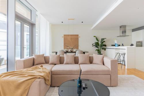 a living room with a couch and a table at Welcome Home - Bluewaters brand new 2-bedroom in Dubai