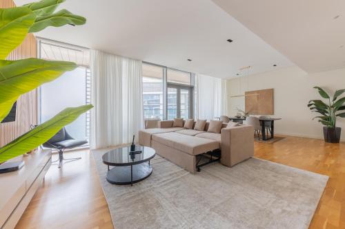 a living room with a couch and a table at Welcome Home - Bluewaters brand new 2-bedroom in Dubai