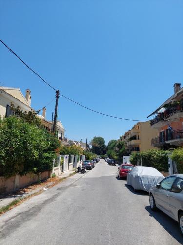 a street with cars parked on the side of the road at Apartment Adriana Mon Repos in Anemómylos