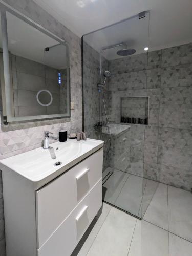 a bathroom with a white sink and a shower at Mirabilis Suites in Vasiliki