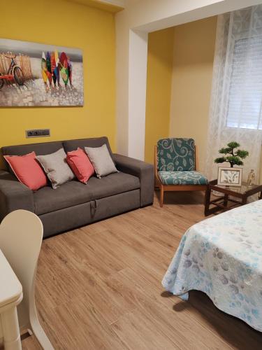 a living room with a couch and a chair at Arenal confort in Marín