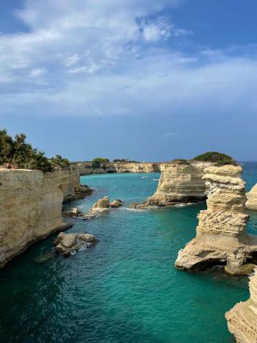an aerial view of a body of water with rocks at Domus Solis Salento in Campi Salentina