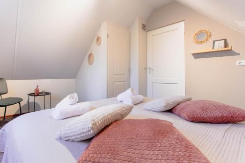 a white bedroom with two pillows on a bed at Forest Retreat in Private House in Lemele