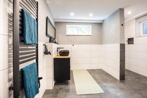 a bathroom with a sink and blue towels at Modernes Apartment in Mistelgau in Mistelgau