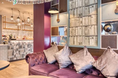 a living room with a purple couch with pillows at Premier Inn Dublin City The Liberties in Dublin