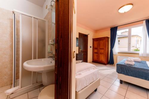 a bathroom with a sink and a shower at Borgo San Martino - Residence Hotel & SPA in Riparbella