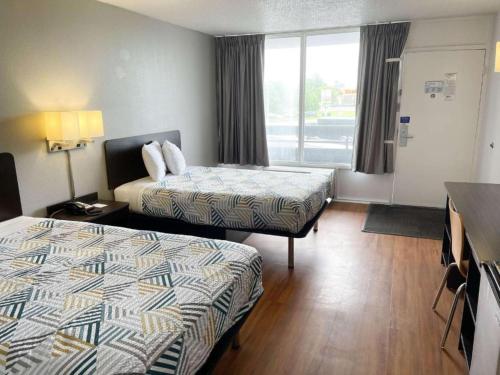 a hotel room with two beds and a window at Motel 6-Troy, OH in Troy