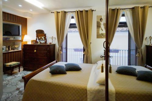 a bedroom with a large bed with pillows on it at B&b Sant'Agata in SantʼAgata deʼ Goti