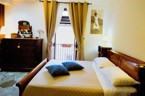 a bedroom with a bed with two pillows and a window at B&b Sant'Agata in SantʼAgata deʼ Goti