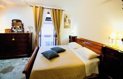 a bedroom with a bed with two pillows on it at B&b Sant'Agata in SantʼAgata deʼ Goti