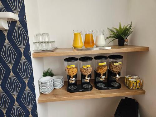 a shelf with four wine glasses and plates on it at The Cumberland in Weymouth