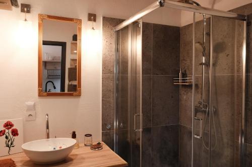a bathroom with a glass shower and a sink at Po Prostu Dobro in Mrągowo