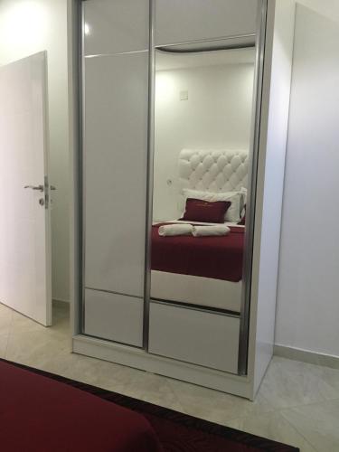a mirror in a room with a bed in it at Queen Kodre Apartments in Ulcinj