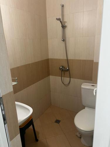a bathroom with a shower and a toilet and a sink at Zapovedni Rai in Primorsko
