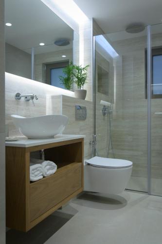 a bathroom with a sink and a toilet and a shower at Kritida Villa Luxury Nest with heated pool in Kokkini Khanion