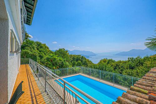 a swimming pool on the side of a building with a balcony at Casa Cora in Agra