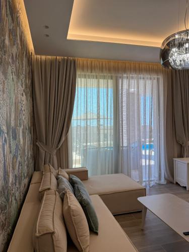a bedroom with a bed and a large window at Turquoise Pool Side Thymus Resort in Himare