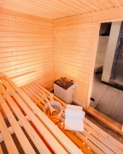 an inside of a wooden sauna with a box at Villa Panoramica Pool & Sauna in Weitersburg