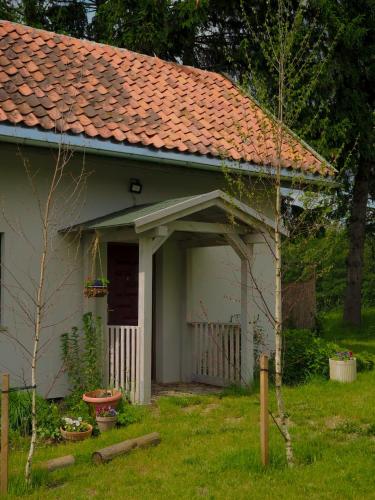a small white house with a red roof at Po Prostu Dobro in Mrągowo