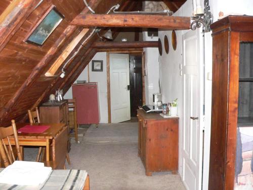 an attic room with a desk and a table at STARA PLEBANIA in Lądek-Zdrój