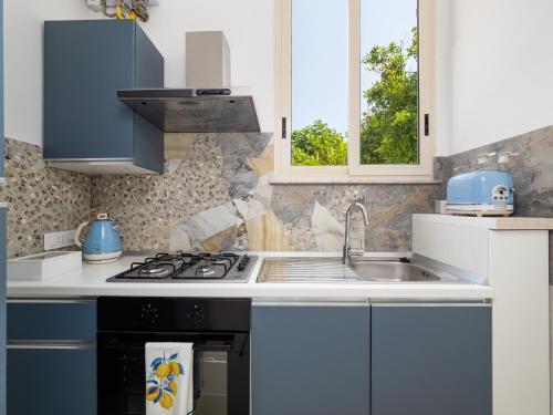 a kitchen with a sink and a stove at EMMEhouse in Sant'Agnello