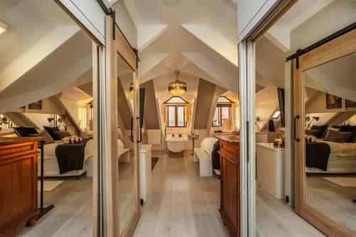 an attic bedroom with two beds and a bathroom at Villa Blau -Stunning Beach Front House Grotto Bay Private Nature Reserve West Coast in Grotto Bay