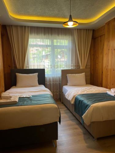 Ένα ή περισσότερα κρεβάτια σε δωμάτιο στο Ela Apart Otel