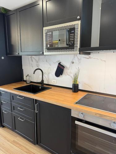 a kitchen with a sink and a microwave at Marbella Beach View and Pool in Marbella