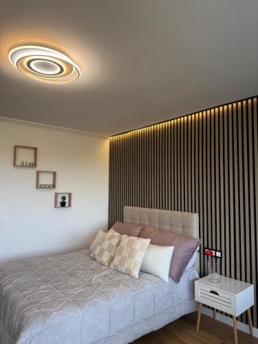 a bedroom with a bed with a large wooden wall at Marbella Beach View and Pool in Marbella