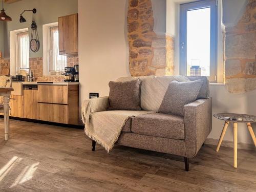 a living room with a couch and a kitchen at Villa Katrinia in Sitia