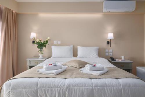 a bedroom with a bed with towels on it at Fedriades Delphi Hotel in Delfoi