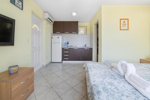 a bedroom with a bed and a kitchen at Apartments Dragičević 6 with Garage in Budva