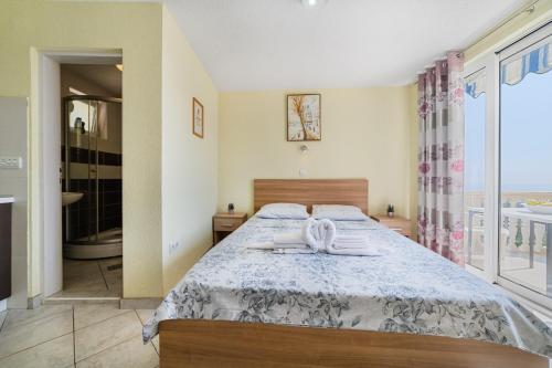 a bedroom with a bed with two towels on it at Apartments Dragičević 6 with Garage in Budva