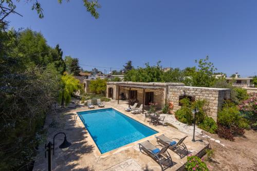 a villa with a swimming pool and a house at Simeon Estate in Droushia
