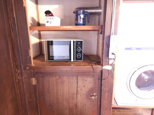 a microwave sitting on a shelf in a room at Former inn "Oyado Wada-juku" - Vacation STAY 36970v in Nagawa