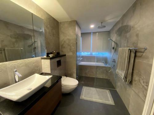 a bathroom with a sink and a toilet and a shower at Super high floor Apartment with 3 bedroom - 60 floor in Singapore